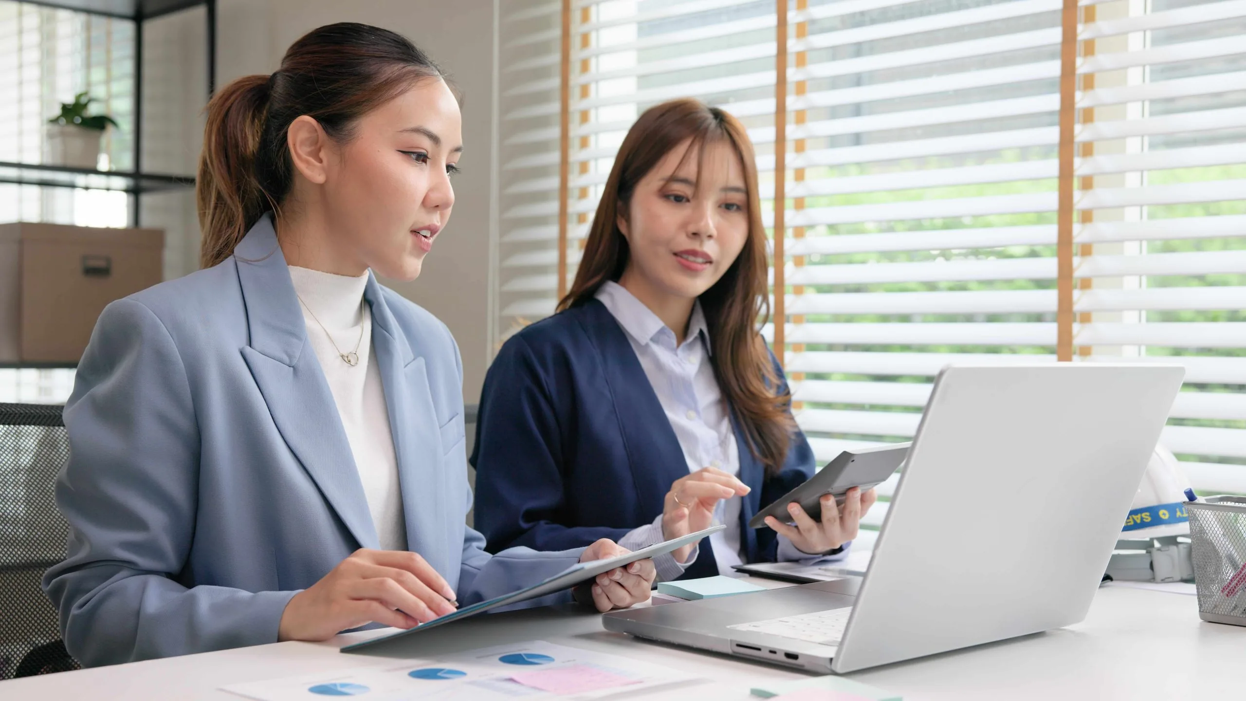 Small business accounting Calgary professionals collaborating over digital devices